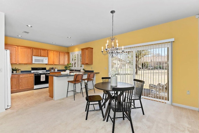 dining space featuring visible vents, baseboards, recessed lighting, a notable chandelier, and light colored carpet