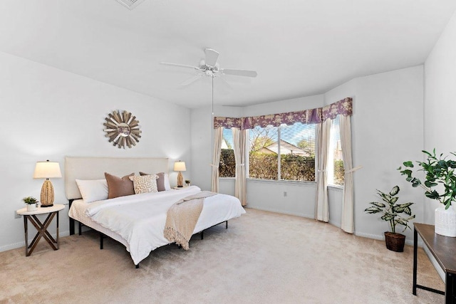 bedroom with light carpet, baseboards, and ceiling fan