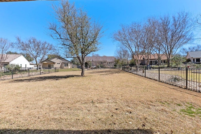 view of yard featuring fence and a residential view