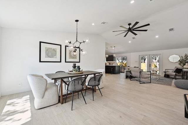 dining room with visible vents, ceiling fan with notable chandelier, recessed lighting, light wood finished floors, and vaulted ceiling