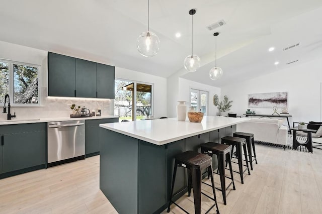 kitchen featuring a sink, light wood-style flooring, visible vents, and stainless steel dishwasher