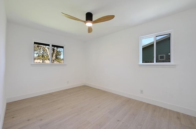 unfurnished room with ceiling fan, light wood-type flooring, and baseboards