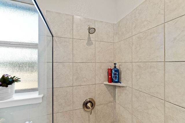 interior details with a tile shower