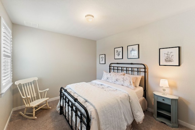 carpeted bedroom featuring baseboards