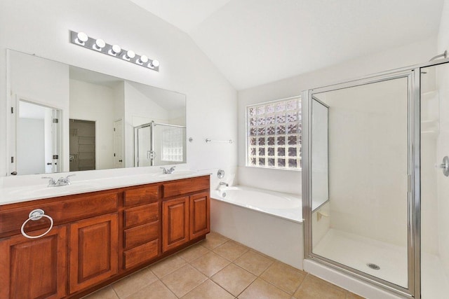 full bath featuring tile patterned floors, a stall shower, vaulted ceiling, and a sink