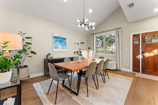 dining room featuring visible vents, baseboards, an inviting chandelier, and light wood finished floors