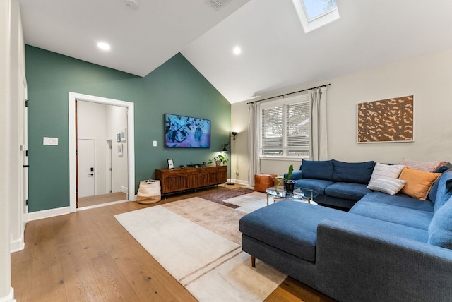 living room featuring recessed lighting, baseboards, lofted ceiling with skylight, and wood-type flooring