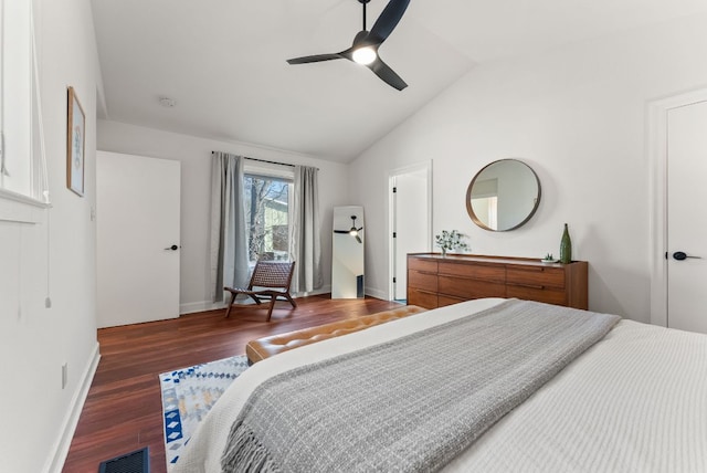 bedroom with visible vents, a ceiling fan, wood finished floors, baseboards, and vaulted ceiling