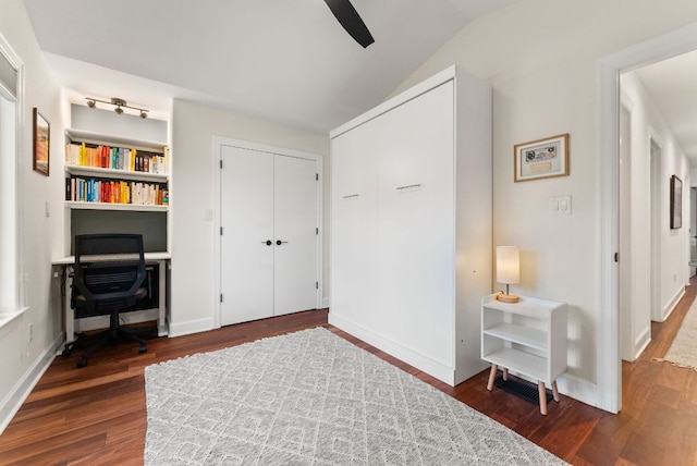 sitting room featuring baseboards, lofted ceiling, wood finished floors, and a ceiling fan