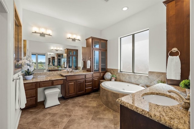 full bathroom with a sink, two vanities, and a bath