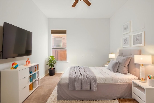 tiled bedroom with baseboards and ceiling fan