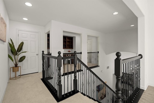 hall with an upstairs landing, carpet flooring, recessed lighting, and baseboards