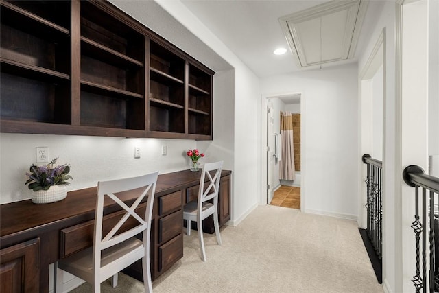 office featuring baseboards, attic access, recessed lighting, built in desk, and light carpet