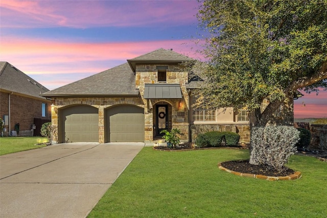 view of front of property with a garage, stone siding, concrete driveway, and a front yard