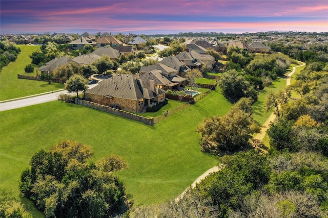 aerial view at dusk featuring a residential view