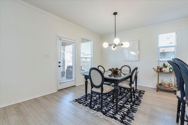 dining area featuring a wealth of natural light, light wood-style flooring, and crown molding