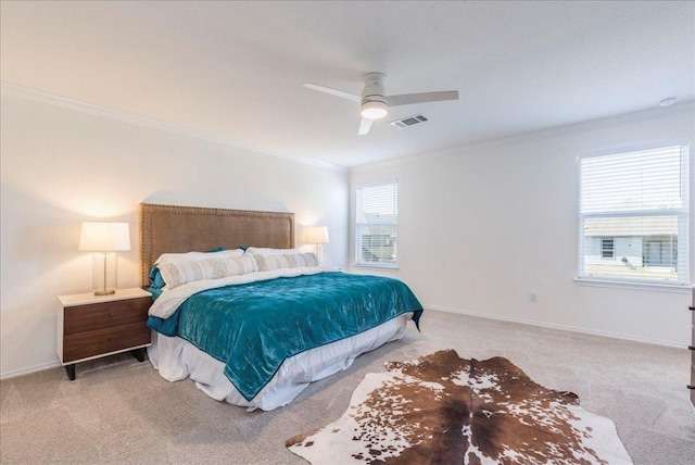 bedroom featuring a ceiling fan, baseboards, visible vents, carpet floors, and ornamental molding