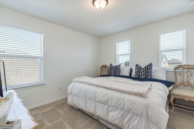 bedroom featuring baseboards and carpet floors