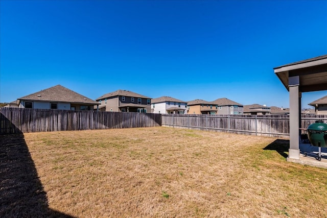 view of yard with a residential view and a fenced backyard