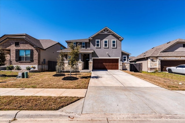 185 Six Shooter Dr, Kyle, TX 78640 - craftsman inspired home featuring an attached garage, driveway, stucco siding, stone siding, and a front lawn