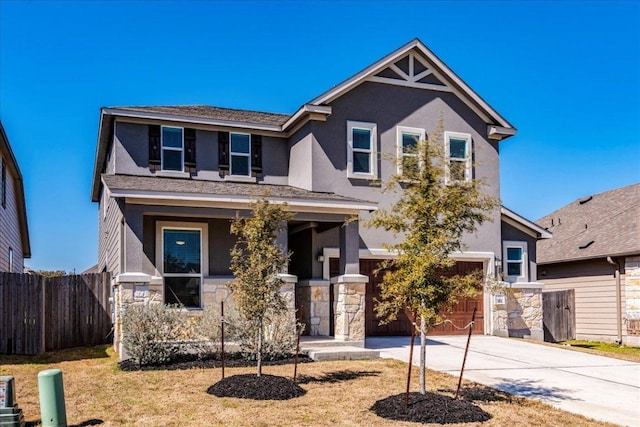 185 Six Shooter Dr, Kyle, TX 78640 - traditional home featuring stucco siding, concrete driveway, a garage, and stone siding