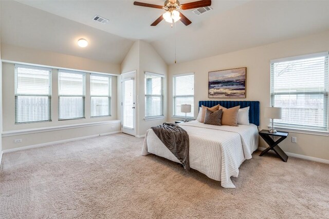 108 Trailstone Dr, Bastrop, TX 78602 - bedroom featuring light carpet, baseboards, multiple windows, vaulted ceiling, and access to exterior
