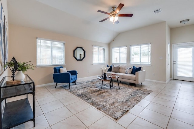 living room featuring a ceiling fan, visible vents, baseboards, light tile patterned flooring, and vaulted ceiling