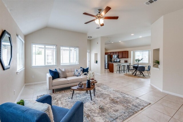 108 Trailstone Dr, Bastrop, TX 78602 - living room featuring plenty of natural light, lofted ceiling, light tile patterned flooring, ceiling fan, and baseboards