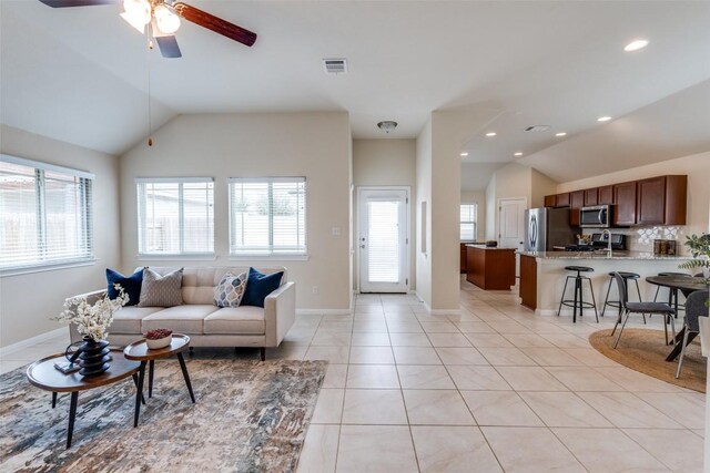 108 Trailstone Dr, Bastrop, TX 78602 - living area featuring lofted ceiling, plenty of natural light, light tile patterned flooring, ceiling fan, and baseboards