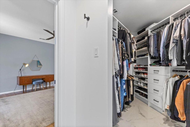 walk in closet with visible vents and marble finish floor