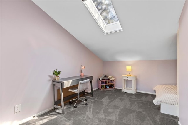 carpeted home office with baseboards and vaulted ceiling with skylight