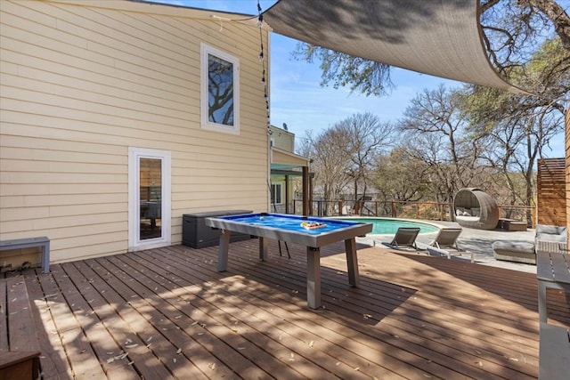 wooden deck featuring a fenced in pool