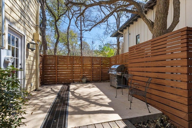 view of patio featuring area for grilling and fence