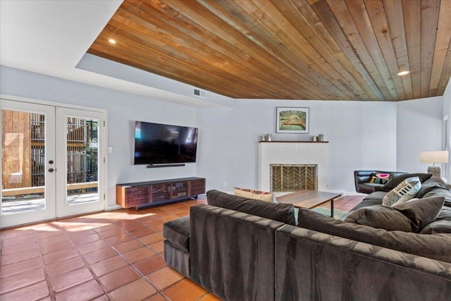 living room featuring tile patterned flooring, visible vents, french doors, a fireplace, and wooden ceiling