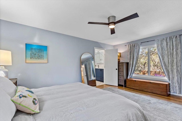 bedroom with a ceiling fan and ensuite bathroom