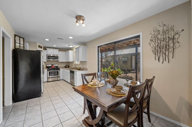 1807 Morning Quail Dr, Austin, TX 78758 - dining area with light tile patterned floors, recessed lighting, and baseboards