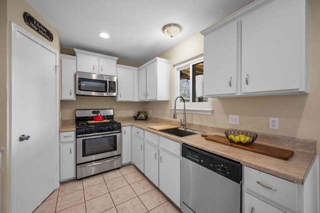 1807 Morning Quail Dr, Austin, TX 78758 - kitchen featuring stainless steel appliances, a sink, light countertops, white cabinetry, and recessed lighting