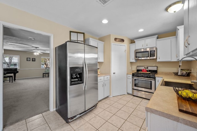 1807 Morning Quail Dr, Austin, TX 78758 - kitchen featuring appliances with stainless steel finishes, a sink, light tile patterned flooring, light countertops, and recessed lighting