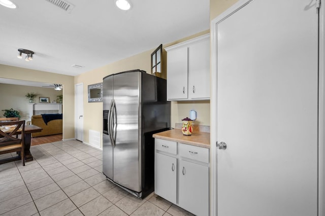 1807 Morning Quail Dr, Austin, TX 78758 - kitchen featuring stainless steel refrigerator with ice dispenser, white cabinets, light countertops, and light tile patterned floors