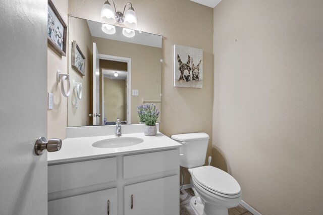 1807 Morning Quail Dr, Austin, TX 78758 - half bath with toilet, vanity, baseboards, and tile patterned floors