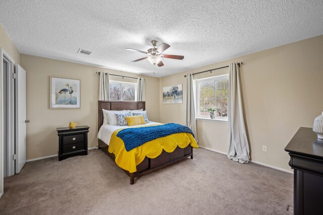 1807 Morning Quail Dr, Austin, TX 78758 - carpeted bedroom featuring a ceiling fan, a textured ceiling, and baseboards