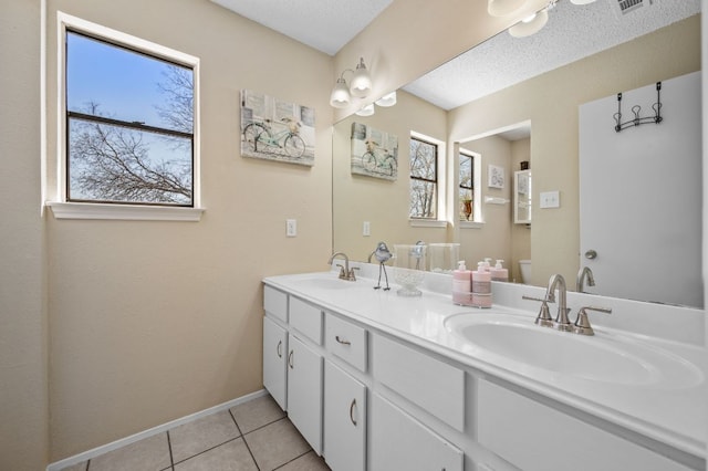 1807 Morning Quail Dr, Austin, TX 78758 - bathroom featuring double vanity, tile patterned flooring, and baseboards