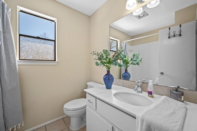 1807 Morning Quail Dr, Austin, TX 78758 - full bath featuring toilet, vanity, tile patterned flooring, a shower with shower curtain, and a textured ceiling