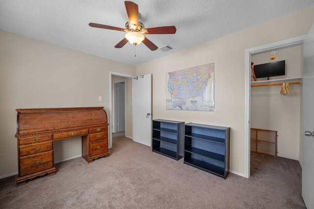 1807 Morning Quail Dr, Austin, TX 78758 - unfurnished bedroom with carpet flooring, an office area, a closet, a textured ceiling, and ceiling fan