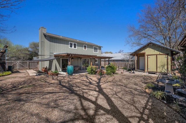 1807 Morning Quail Dr, Austin, TX 78758 - rear view of property featuring a chimney, a fenced backyard, a patio, and a gate