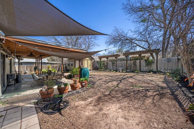 1807 Morning Quail Dr, Austin, TX 78758 - fenced backyard featuring a patio area, a pergola, and a ceiling fan
