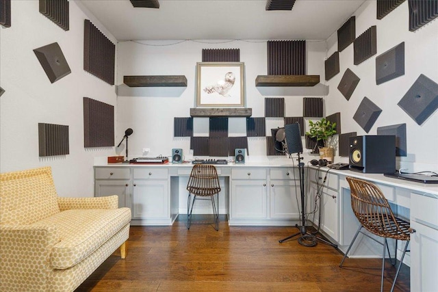 office area featuring visible vents, built in desk, and dark wood-style flooring