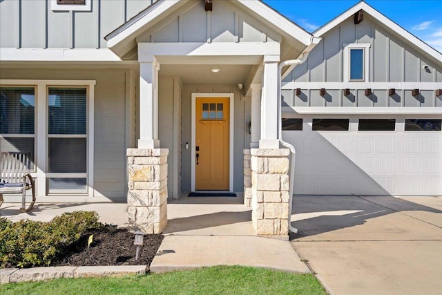 entrance to property featuring concrete driveway and board and batten siding