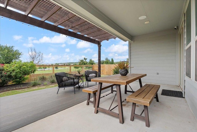 view of patio / terrace featuring outdoor dining space, a deck, a pergola, and fence