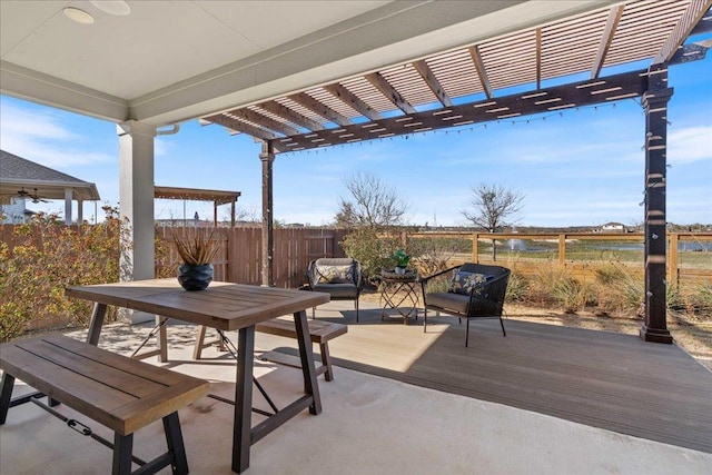 view of patio featuring fence, a pergola, and a wooden deck